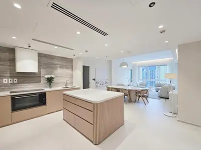 a kitchen with a table and a dining room at Marina Residence 5, Palm Jumeirah - Mint Stay in Dubai