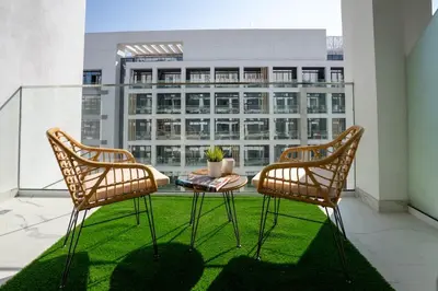 two chairs and a table on a balcony at Airstay - Chic Studio in Meydan Azizi 65 - Monthly Offer Available in Dubai