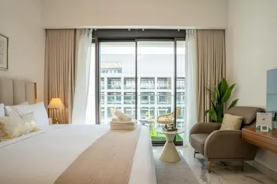 a large white bedroom with a large bed and a couch at Airstay - Chic Studio in Meydan Azizi 65 - Monthly Offer Available in Dubai