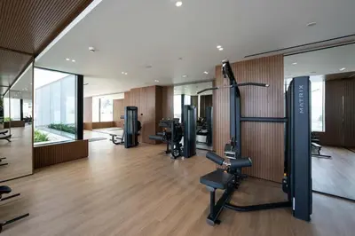 a gym with treadmills and exercise equipment in a building at Warm Minimal 1BR in Binghatti Tulip with Free Parking! in Dubai