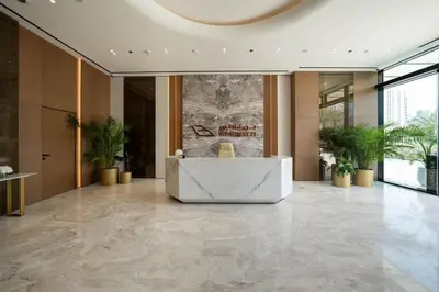 a lobby with a reception desk in a building at Warm Minimal 1BR in Binghatti Tulip with Free Parking! in Dubai