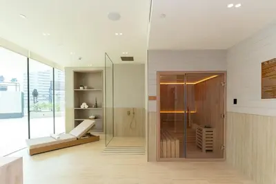 a bathroom with a shower and a glass door at Calm 1BR Haven with Private Pool in Binghatti Royale in Dubai