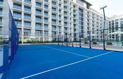 a tennis court in front of a building at Softline Studio with Open Views in Binghatti Phoenix! in Dubai