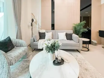 a living room with a couch and a coffee table at Family-Friendly 1BR Apt with Study Room and Pool Views! in Dubai