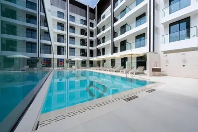 an image of a swimming pool in a building at Family-Friendly 1BR Apt with Study Room and Pool Views! in Dubai