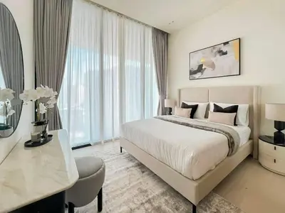 a white bedroom with a large bed and a desk at Binghatti Phantom's Elegant 1BR with Private Pool! in Dubai