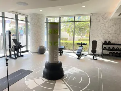 a fitness room with a pole in the middle at Stunning and Cozy Home with Marina and Sea View in Dubai