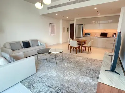 a living room with a couch and a table at Stunning and Cozy Home with Marina and Sea View in Dubai