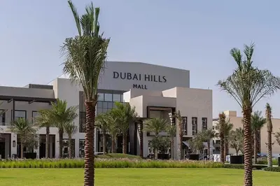 a building with palm trees in front of it at 2 Bed with Direct Park Access - Calm and Peaceful in Dubai