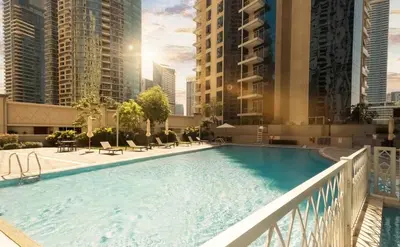 a large swimming pool on a balcony with buildings at Dubai Marina Penthouse Suite - Prime Location in Dubai
