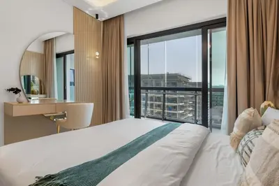 a bedroom with a bed and a large window at Modern 1BR Apartment w Balcony in Meydan in Dubai