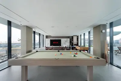 a pool table in a room with a tv at Oxford Gardens Premium Studio with Cinema & Game Room in Dubai