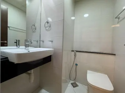 a bathroom with a sink and a toilet at Werova - Urban Living 1BR Apartment in JVC in Dubai