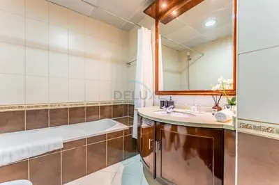 a bathroom with a tub and a sink at Minutes from Marina Promenade, Surrounded by Shops, and a Short Drive to Ain Dubai, Opal Tower, Dubai Marina by Deluxe Holiday Homes in Dubai