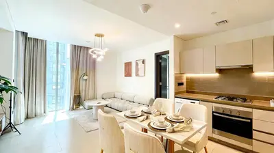 a kitchen and living room with a table and chairs at Sohba Creek Vistas Luxury 2 Bedroom with Free Parking in Downtown Dubai Near Burj Khalifa in Dubai
