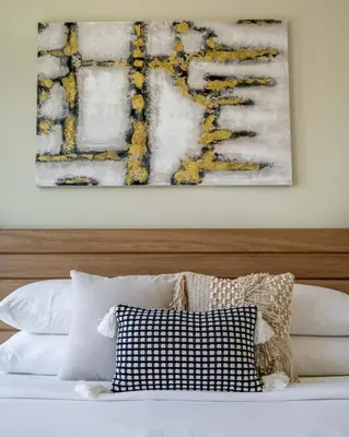 a bed with two pillows and a painting on the wall at Iconic Burj Views l Elegant 2BR at Burj Royale in Dubai