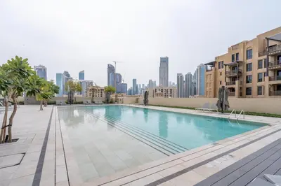 a swimming pool with a city skyline in the background at Iconic Burj Views l Elegant 2BR at Burj Royale in Dubai