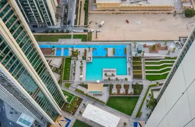 an overhead view of a pool between two buildings at BAZ HOMES - Burj Khalifa View 2BR Connected to Dubai Mall in Dubai