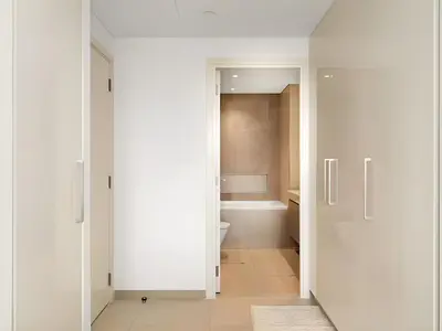 a bathroom with a toilet and a white door at BAZ HOMES - Burj Khalifa View 2BR Connected to Dubai Mall in Dubai