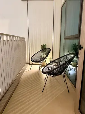 two chairs sitting on top of a balcony at BAZ HOMES - Burj Khalifa View 2BR Connected to Dubai Mall in Dubai