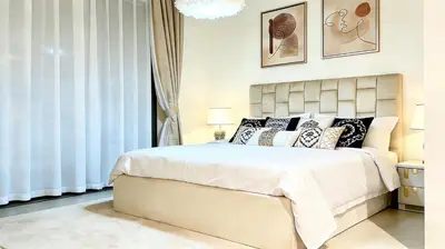 a bedroom with a large white bed with pillows at Sohba Creek Vistas Luxury 2 Bedroom with Free Parking in Downtown Dubai Near Burj Khalifa in Dubai