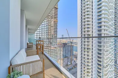 a balcony with a view of a large building at 2BR Beachfront Apartment at Palace Beach Residence in Dubai