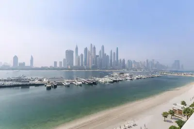 a view of a city with a beach and buildings at 2BR Beachfront Apartment at Palace Beach Residence in Dubai