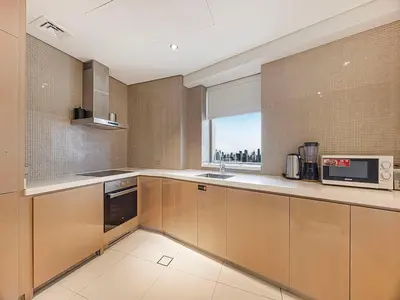 a kitchen with a sink and a microwave at Spacious 3BR in Paramount Tower Luxury Living in Dubai