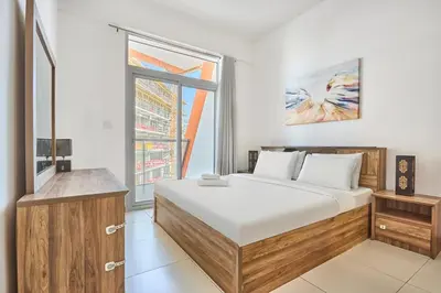 a bedroom with a large bed and a window at Urban and Central - 1BR at Binghatti Gateway in Dubai