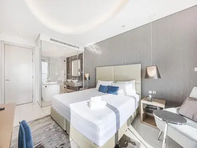 a bedroom with a large bed and a bathroom at Spacious 3BR in Paramount Tower Luxury Living in Dubai