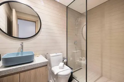 a bathroom with a toilet and a sink and a mirror at Brand New Exclusive 2BR, Burj and Canal View in Dubai