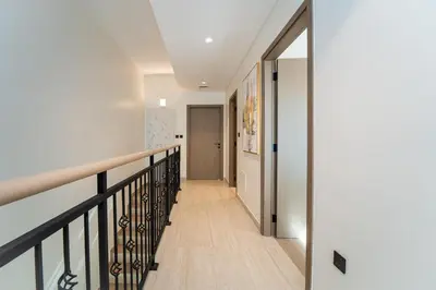 a hallway of a house with a staircase and a door at Stylish 4 Bedroom Home with Garden in DAMAC Lagoons in Dubai Marina