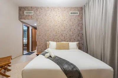 a bedroom with a large white bed in a room at Premium 1BR King Bed Dubai Healthcare City in Dubai