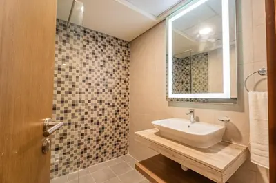 a bathroom with a sink and a mirror at Premium 1BR King Bed Dubai Healthcare City in Dubai