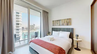 a bedroom with a large bed and a large window at Vacationer l Classy 1 Bedroom l Yacht Views l Private Beach in Dubai