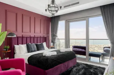 a purple bedroom with a large bed with a purple headboard at 5-Star Living | Luxury 2B & Amenities in Dubai