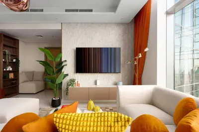 a living room with a white couch and yellow pillows at 5-Star Living | Luxury 2B & Amenities in Dubai