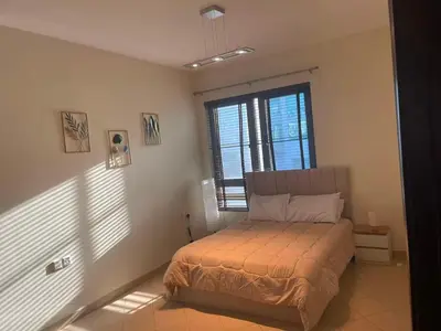 a bedroom with a bed and a large window at Stunning rooms in the Canal in Dubai