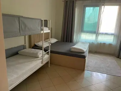 two bunk beds in a room with a window at Stunning rooms in the Canal in Dubai