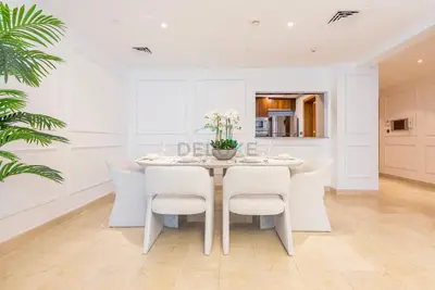 a white dining room with a table and chairs at Marina Canal View Apartment, Walking Distance to The Metro and Tram, Near The Beach and Top Dining - Bayside Residence, Dubai Marina by Deluxe Holiday Homes in Dubai