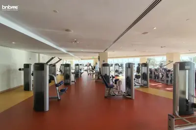 a gym with treadmills and cardio equipment in a building at bnbmehomes - Tiara Residence in Dubai