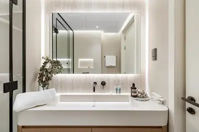 a bathroom with a large white sink and a mirror at Upscale City Walk 3BR plus Maid Near Dubai Mall in Dubai