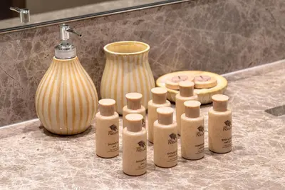 a group of bottles sitting on a counter next to a vase at Stunning 2BR with Full Burj View in the Opera District in Dubai