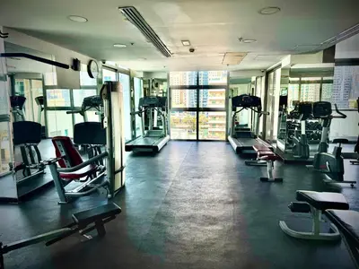 a gym with rows of treadmills and machines at The Urban Retreat in Dubai