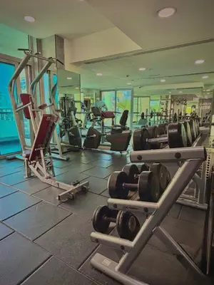 a gym with rows of treadmills and machines at The Urban Retreat in Dubai