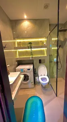 a bathroom with a toilet and a washing machine at The Urban Retreat in Dubai