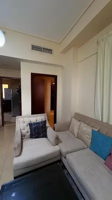 a living room with a white couch in a room at 1 Bhk with open terrace in Dubai