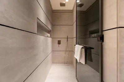 a bathroom with a shower and a glass door at GuestReady | Stylish 1BR Penthouse Retreat in Dubai