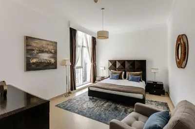 a bedroom with a bed and a couch at VayK - Modern 4BR in Dubai Marina with Sea View in Dubai