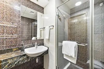 a bathroom with a sink and a mirror at VayK - Modern and Central 1BR in the Marina in Dubai